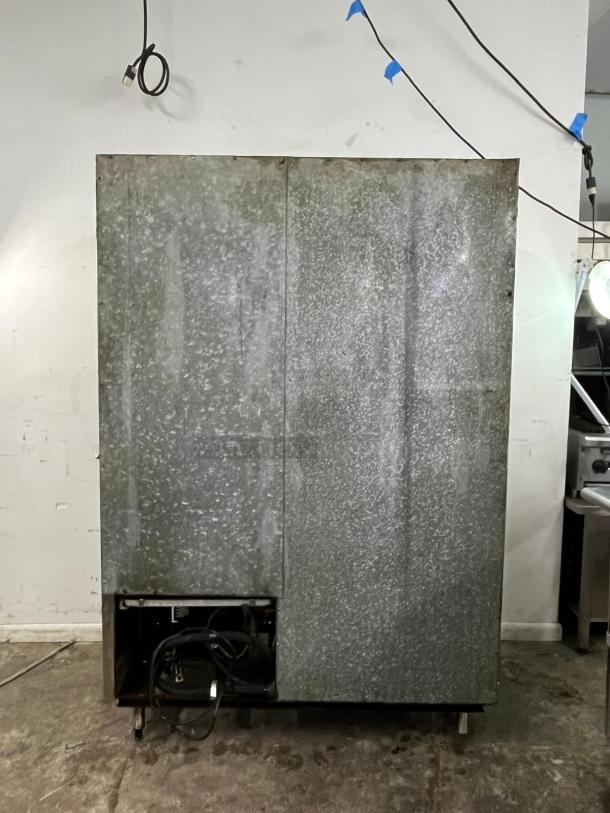 GLENCO 2 Door Commercial Freezer, Model SLA-28-S, steel finish, visible wear, exposed wiring at bottom, sturdy condition.