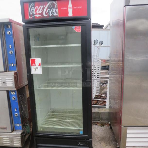 True GDM-26EM glass display cooler with 4 racks, working condition. Dimensions: 29.5x29.5x78.5 inches. Coca-Cola branding.
