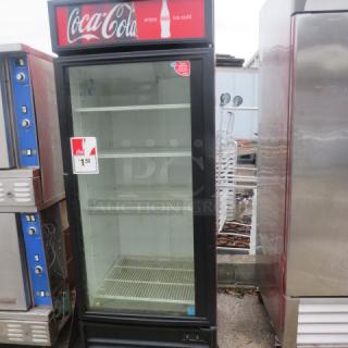 True GDM-26EM glass display cooler with 4 racks, working condition. Dimensions: 29.5x29.5x78.5 inches. Coca-Cola branding.