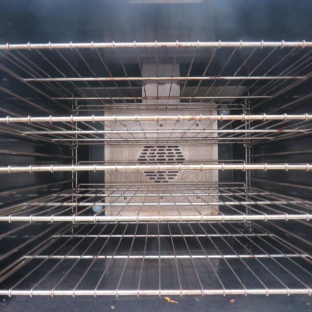 Southbend natural gas convection oven interior with 8 racks, double stack, on casters, dimensions 40x39x72.5 inches.