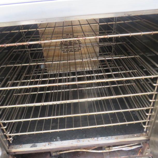 Southbend natural gas double stack convection oven with 8 racks on casters, 40x39x72.5 inches, used condition.