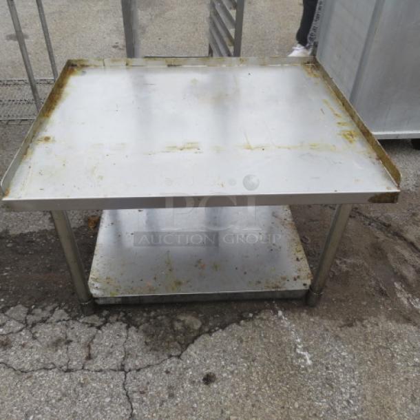 Stainless steel equipment table with under shelf, 36x30x24 inches. Some surface wear and rust visible.