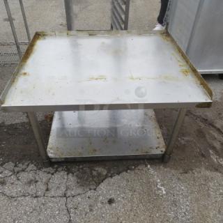 Stainless steel equipment table with under shelf, 36x30x24 inches. Some surface wear and rust visible.