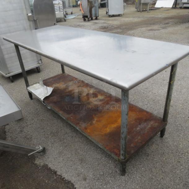Stainless steel table with rusted under shelf, 72x30x34 inches, used condition.