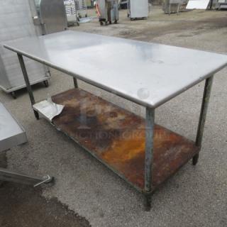 Stainless steel table with rusted under shelf, 72x30x34 inches, used condition.