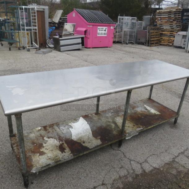 Stainless steel table with under shelf, dimensions 97x29.5x34 inches, in fair condition with visible wear and rust on shelf.