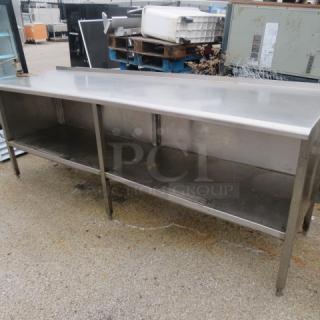 Stainless steel work table with under shelf, includes Edlund 10lb can opener. Dimensions: 96x29.5x37 inches. Used condition.