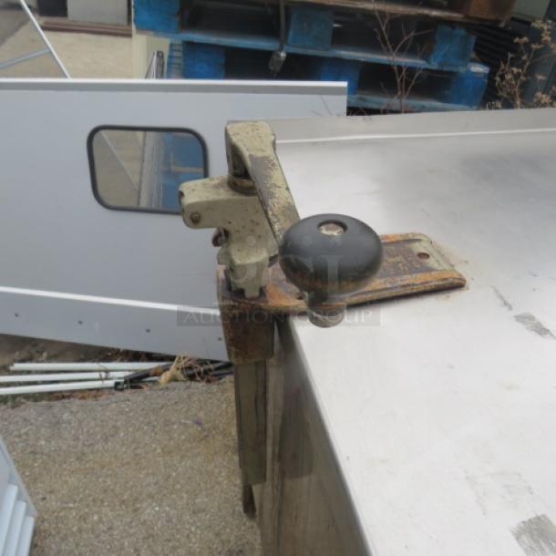 Stainless steel work table with SS under shelf, Edlund 10lb can opener attached, dimensions 96x29.5x37 inches.