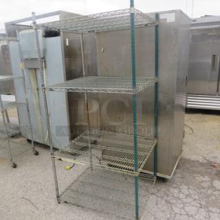 Metro metal shelf unit with 4 tiers, 35x30x75 inches. Features wire construction, sturdy frame. Used condition.