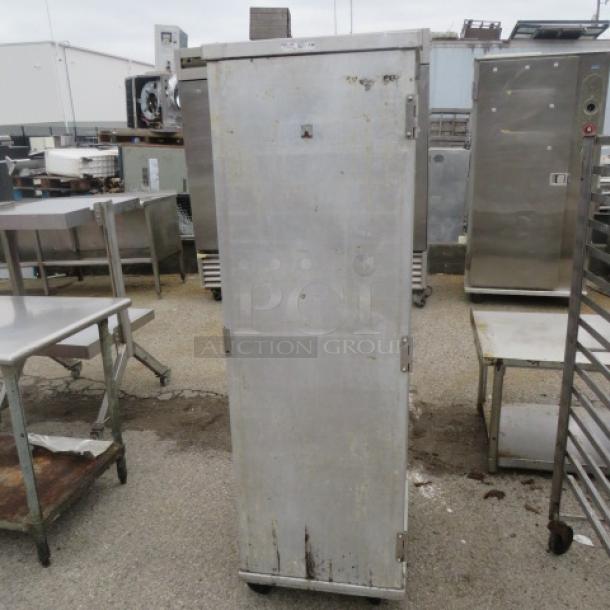Winholt aluminum 1-door holding cabinet on casters, 20x26.5x67.5 inches. Used condition with visible wear. Ideal for storage.