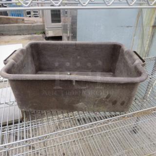 Brown plastic bussing tub with handles, signs of wear, placed on a metal rack. Durable for commercial use.