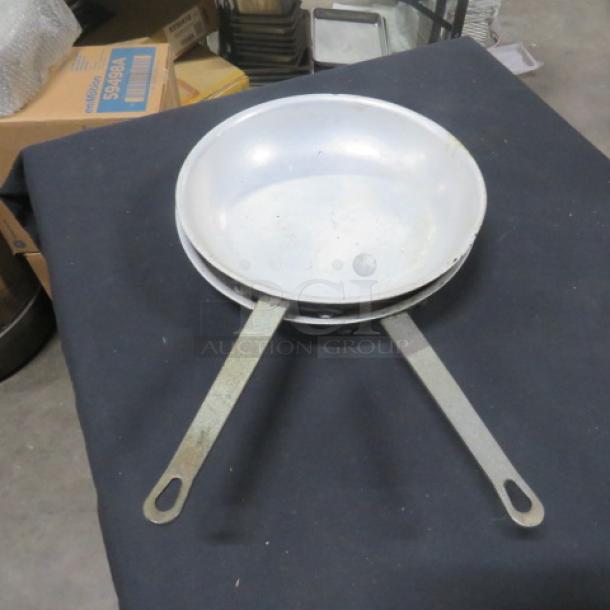 11-inch sauté pan, metal construction, used condition, dual-handle design, no visible markings or brand labels.