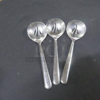 Stainless steel slotted spoons set, 3 pieces, with sleek design and flame-shaped slots, in good condition.