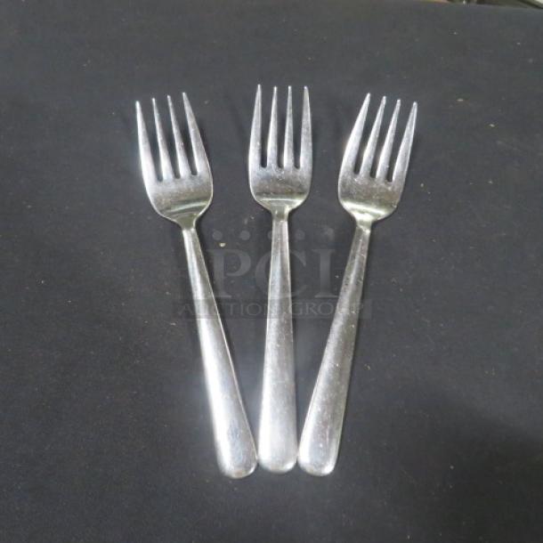 Stainless steel serving forks, 3-piece set. Slightly used condition, shiny finish, ideal for dining or entertaining.