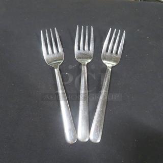 Stainless steel serving forks, 3-piece set. Slightly used condition, shiny finish, ideal for dining or entertaining.