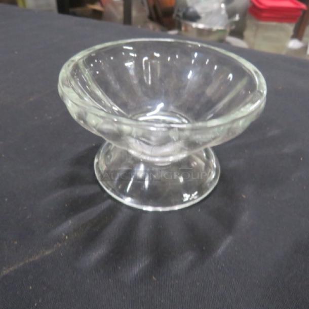 Clear glass sherbet dish with a wide bowl and stable base, in good condition. No visible markings or labels.