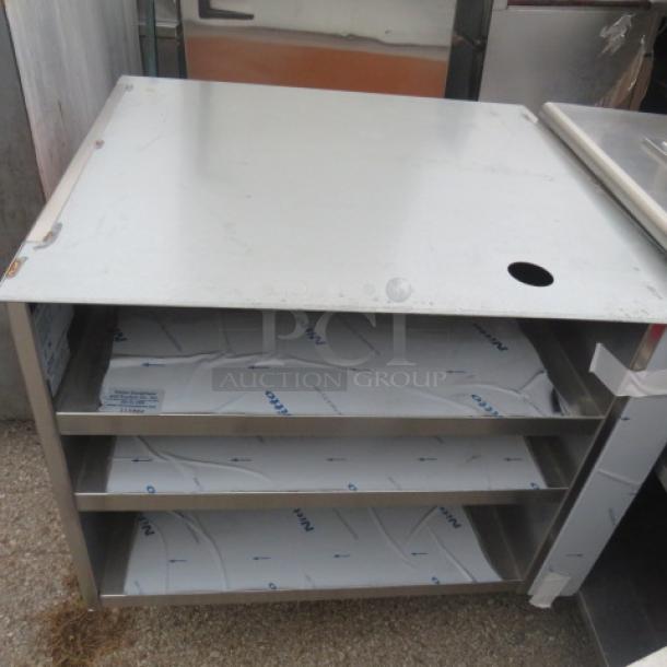 Stainless steel drink table with single door, three shelves, and hole on top. Measures 37x35x37 inches.