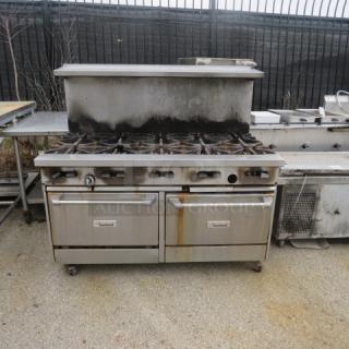 Garland 10-burner natural gas range with stainless steel overshelf on casters. Visible wear, includes oven doors.