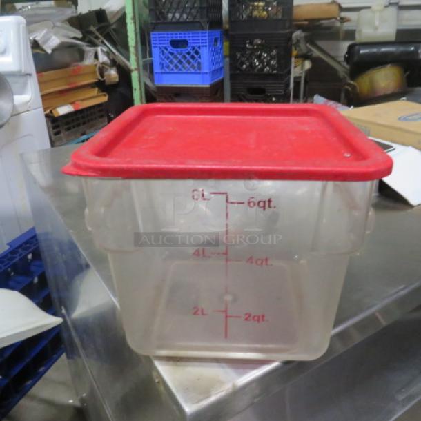 6-quart food storage container with red lid, clear body showing measurement markings. Good condition.