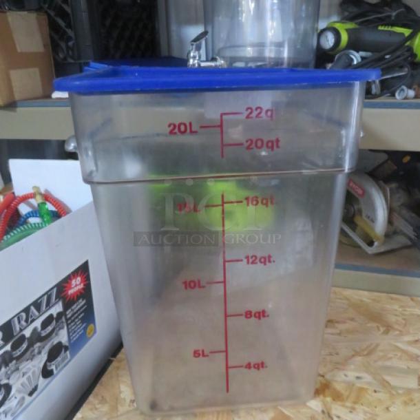 Clear 22-quart food storage container with blue lid, red measurement markings in quarts and liters.