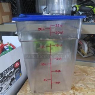 Clear 22-quart food storage container with blue lid, red measurement markings in quarts and liters.