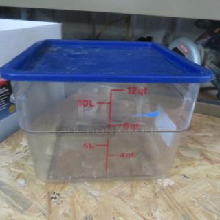 12-quart food storage container with lid, clear with red measurement markings, blue lid, used condition.