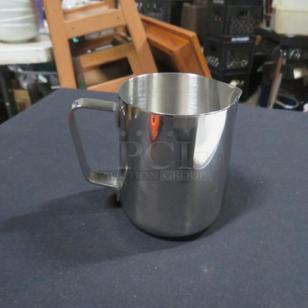 New 12oz stainless steel frothing pitcher with handle, shiny finish, ideal for milk frothing and steaming.