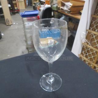 Clear stem wine glass, gently used, no visible chips or cracks, standard size, perfect for dining or collection.