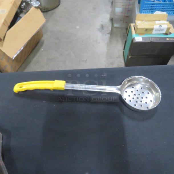 5oz stainless steel perforated spoodle with yellow handle. Marked "2XBID." In good condition. Ideal for kitchen use.