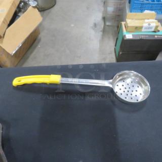 5oz stainless steel perforated spoodle with yellow handle. Marked "2XBID." In good condition. Ideal for kitchen use.