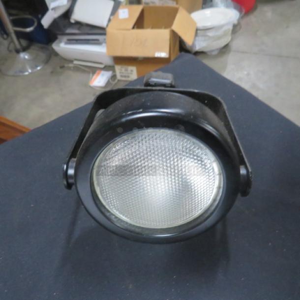 Black Damar Light 4XBID in good condition, featuring a textured lens and adjustable bracket. Suitable for industrial use.