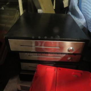 Black cash drawer with stainless steel front, featuring three slots and a knob. Appears in used condition.