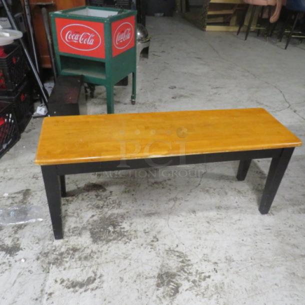 Wooden bench, 44x14x18 inches, natural wood top, black legs, good condition.