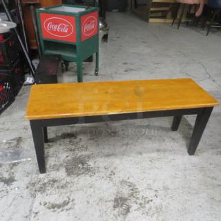Wooden bench, 44x14x18 inches, natural wood top, black legs, good condition.