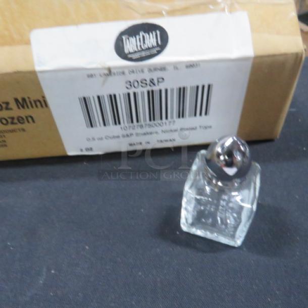 A case containing 24 new glass salt/pepper shakers with nickel-plated tops, shown with packaging label for identification.