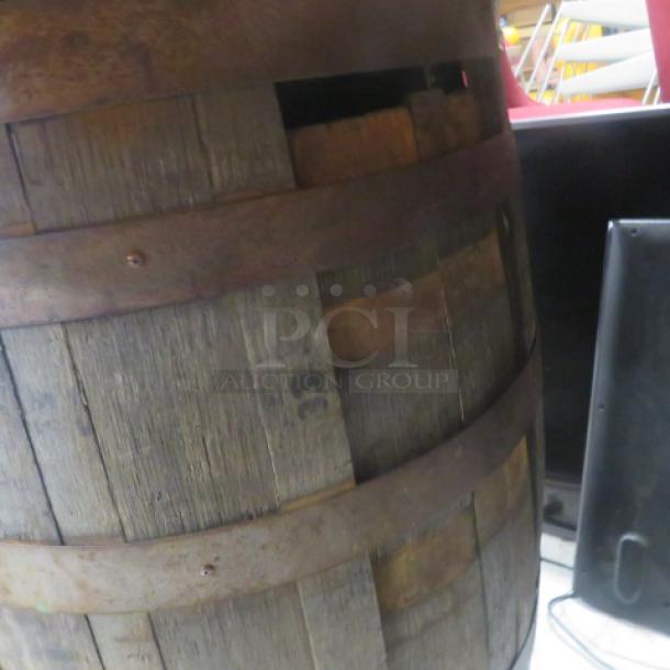 Wooden whiskey barrel with wooden top, measuring 41x40 inches. Features rustic appearance and aged wood, suitable for decor or storage.