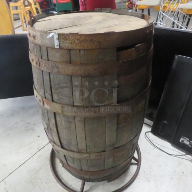 Wooden whiskey barrel with wooden top, 41x40 inches, aged condition. Features metal bands and rustic appearance.