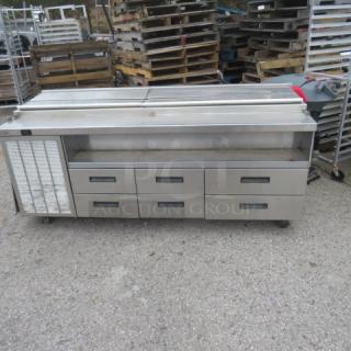 Delfield F18SC85 refrigerated prep table, 6 drawers, stainless steel, on casters, 83x31x38 inches, 115V, good condition.