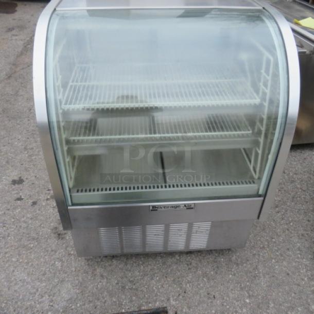 Beverage Air CDR3-1 curved glass display case, 3 shelves, on casters, 115V, stainless steel finish, measures 37.5x34x50 inches.
