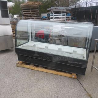 Federal Curved Glass Display Case, Model CGR7748, 120 Volt, 77x34x48.5 inches. Good condition on a wooden pallet.