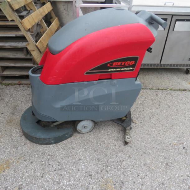 Betco Stealth Carpet Cleaner ASD20B, red and gray, used condition, visible Betco logo, wheels intact.