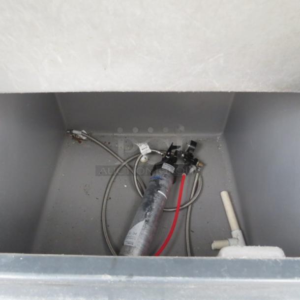 Hoshizaki ice bin, interior view, showing attached pipes and fittings, in used condition.