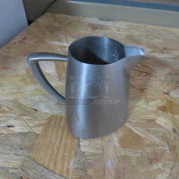 Vollrath Stainless Steel Creamer, model 46308, gently used, with a sleek handle and pour spout.