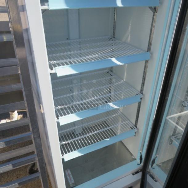 Avantco 1 Door Glass Display Cooler, Model 178GDC10HCW, with 4 shelves. Measures 22x22x63 inches. 115 Volt. In working condition.