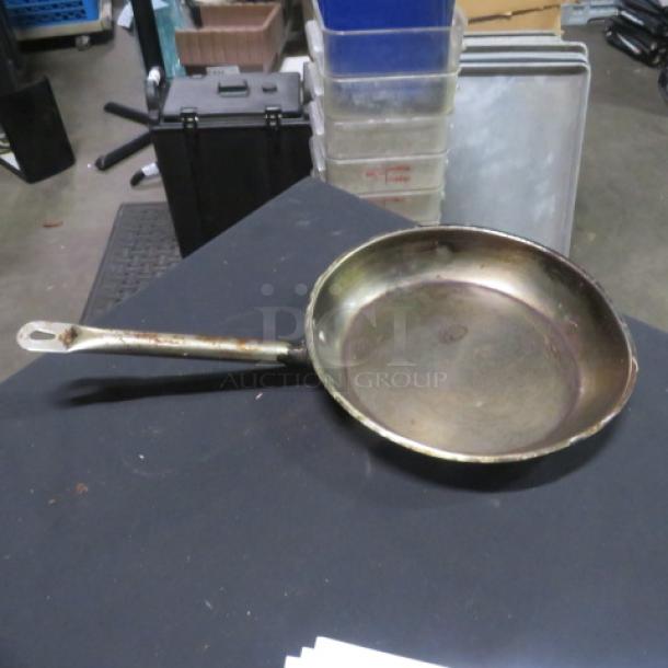 Stainless steel 12-inch sauté pan, well-used condition, visible wear and tarnish, sturdy handle, suitable for restoration.