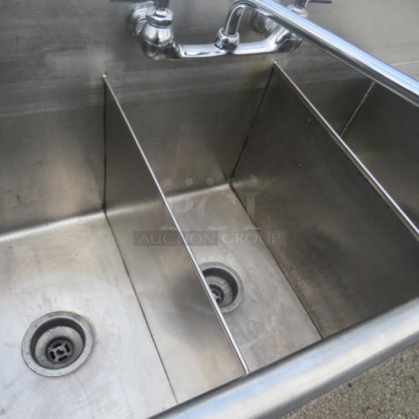 Stainless steel triple bowl sink with faucet, right side drain board, dimensions 48x19x33, slight wear visible.