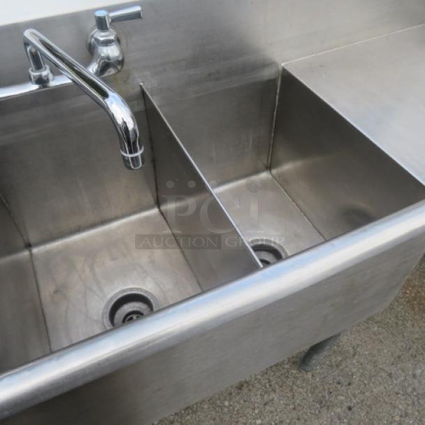 Stainless steel triple bowl sink with faucet, right side drain board, 48x19x33 inches. Good condition, ideal for commercial use.