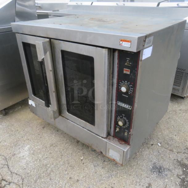 Hobart natural gas convection oven, dimensions 40x31x31, includes 3 racks. Used condition, stainless steel exterior, visible controls.