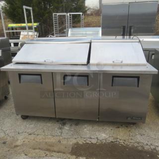 True TSSU-72-30M-B-ST refrigerated prep table, 3-door, on casters, stainless steel, 72x34x48 inches, working condition.