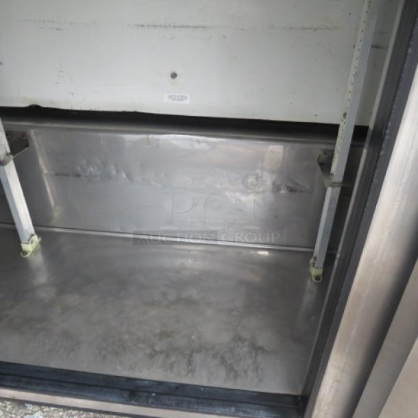 True 3 Door Refrigerated Prep Table, model TSSU-72-30M-B-ST, interior view, stainless steel, on casters, 115 Volt.